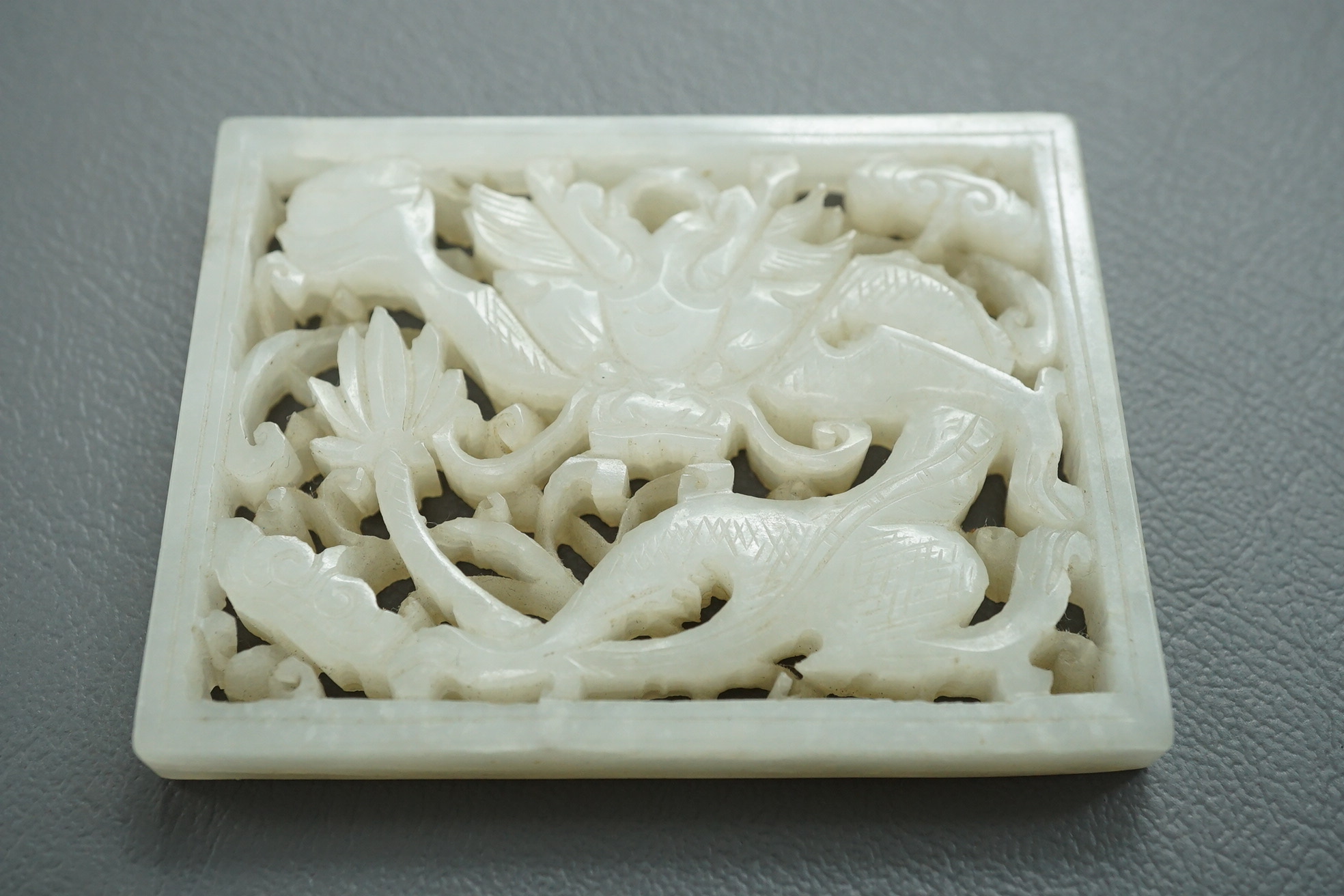 A Chinese white and black jade figure of a recumbent tiger, Song dynasty